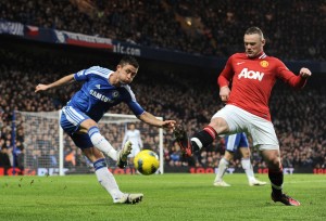 Wayne Rooney of Manchester United blocks a clearance by Gary Cahill of Chelsea